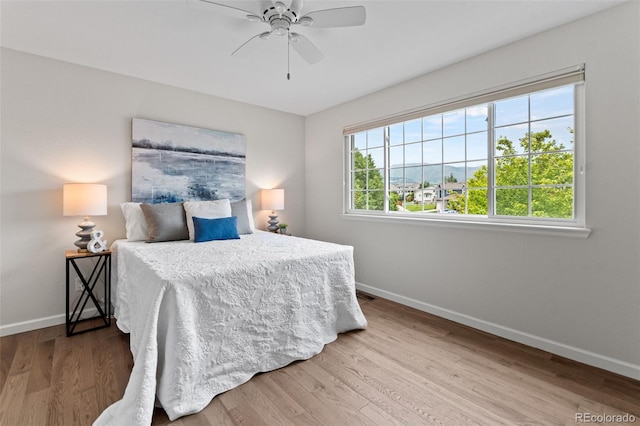 5980 Dunraven Ct, Golden, CO 80403 - bedroom featuring wood finished floors and ceiling fan