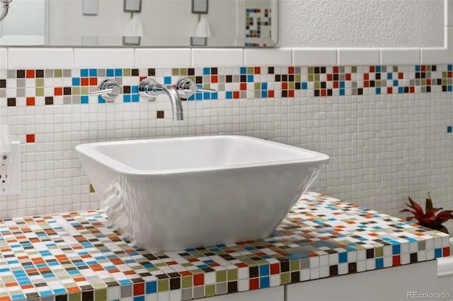 5980 Dunraven Ct, Golden, CO 80403 - bathroom featuring tile walls and tasteful backsplash