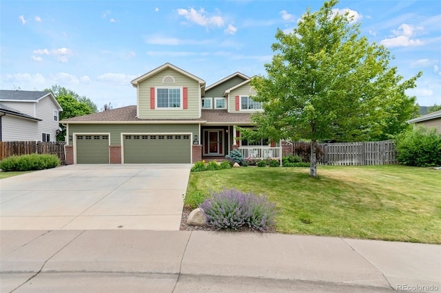 5980 Dunraven Ct, Golden, CO 80403 - view of front facade featuring driveway, brick siding, covered porch, and a garage