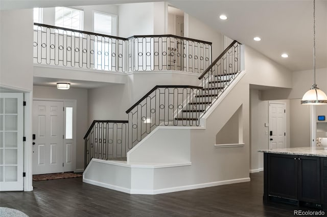 5980 Dunraven Ct, Golden, CO 80403 - stairway featuring a towering ceiling, wood finished floors, healthy amount of natural light, and recessed lighting