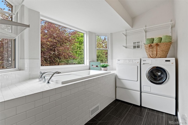 5980 Dunraven Ct, Golden, CO 80403 - washroom with washer and dryer and dark tile patterned floors