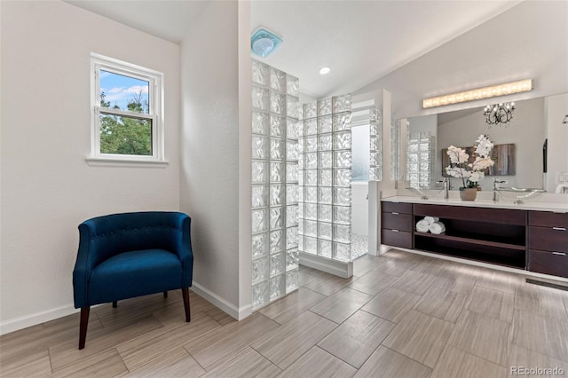 5980 Dunraven Ct, Golden, CO 80403 - full bath featuring vaulted ceiling, a walk in shower, double vanity, wood finish floors, and a chandelier