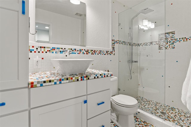 5980 Dunraven Ct, Golden, CO 80403 - bathroom with tile walls, a stall shower, vanity, and a wainscoted wall