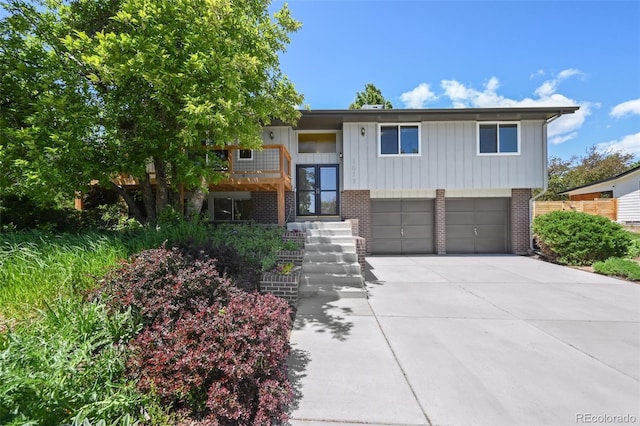 1073 Xenon St, Golden, CO 80401 - raised ranch with brick siding, driveway, a garage, and a balcony