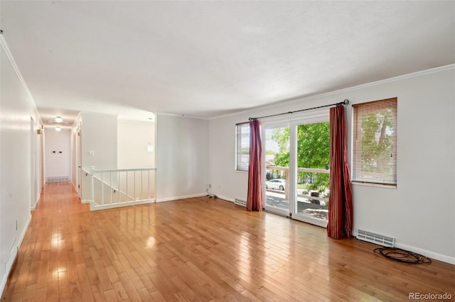 1073 Xenon St, Golden, CO 80401 - spare room featuring ornamental molding, light wood-style flooring, baseboards, and attic access