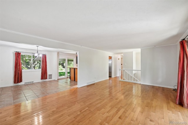 1073 Xenon St, Golden, CO 80401 - unfurnished living room featuring light wood-style flooring, a chandelier, and baseboards
