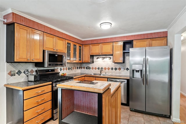 1073 Xenon St, Golden, CO 80401 - kitchen featuring appliances with stainless steel finishes, a sink, backsplash, a kitchen island, and ornamental molding