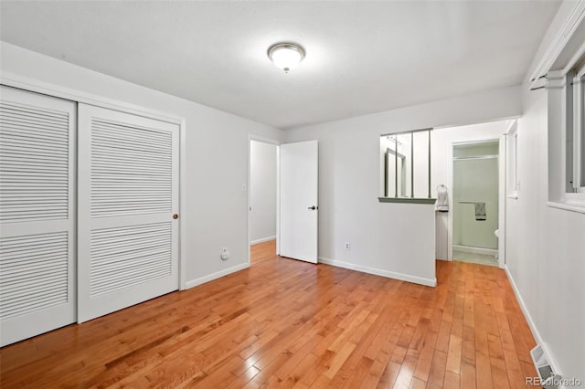 1073 Xenon St, Golden, CO 80401 - unfurnished bedroom with light wood finished floors, baseboards, a closet, and ensuite bath