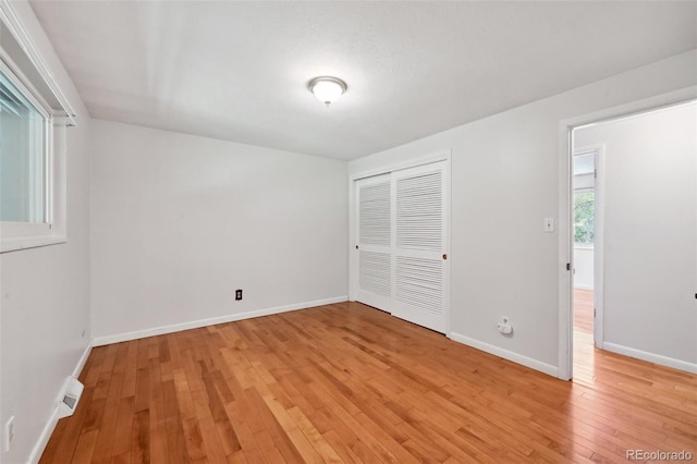 1073 Xenon St, Golden, CO 80401 - unfurnished bedroom with light wood-type flooring, a closet, and baseboards