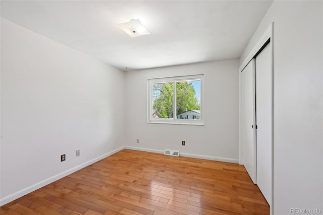 1073 Xenon St, Golden, CO 80401 - unfurnished bedroom with light wood-style flooring, baseboards, and a closet