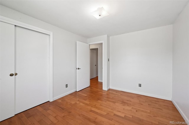 1073 Xenon St, Golden, CO 80401 - unfurnished bedroom with light wood finished floors, baseboards, and a closet