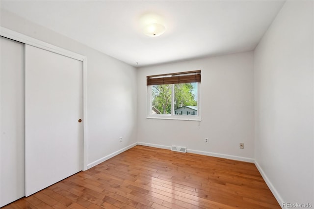 1073 Xenon St, Golden, CO 80401 - unfurnished bedroom with wood-type flooring, a closet, and baseboards
