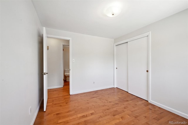 1073 Xenon St, Golden, CO 80401 - unfurnished bedroom with light wood finished floors, a closet, and baseboards