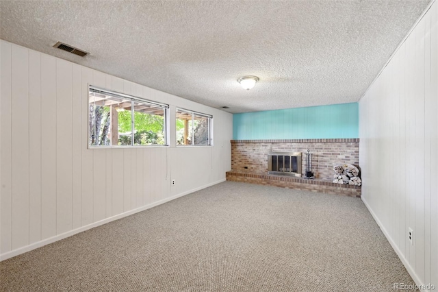 1073 Xenon St, Golden, CO 80401 - unfurnished living room with a fireplace, a textured ceiling, carpet floors, baseboards, and wood walls