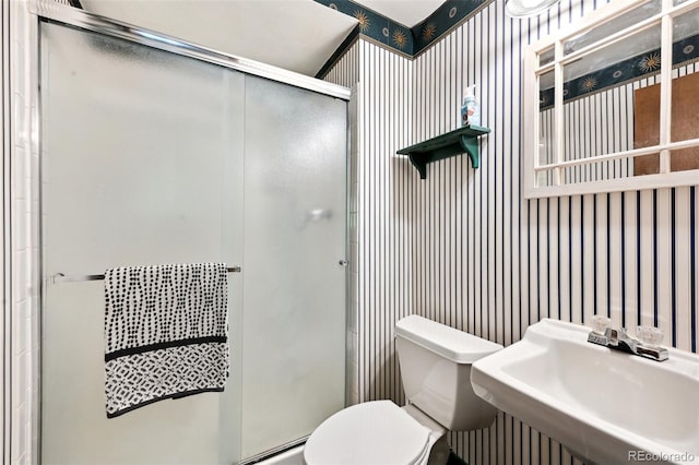 1073 Xenon St, Golden, CO 80401 - bathroom with toilet, a stall shower, wallpapered walls, and a sink