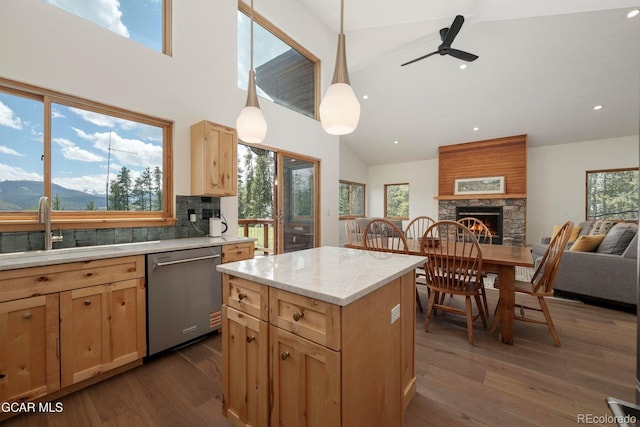 452 Gcr 835, Fraser, CO 80442 - kitchen with stainless steel dishwasher, a fireplace, high vaulted ceiling, open floor plan, and light brown cabinetry