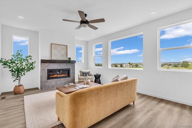 900 Eldorado Ln, Louisville, CO 80027 - living room with a tiled fireplace, healthy amount of natural light, light wood-type flooring, and recessed lighting