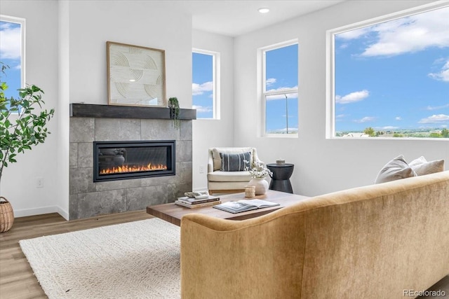 900 Eldorado Ln, Louisville, CO 80027 - living area with wood finished floors, a tile fireplace, plenty of natural light, and recessed lighting