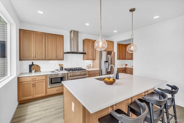 900 Eldorado Ln, Louisville, CO 80027 - kitchen featuring wall chimney exhaust hood, high quality appliances, backsplash, light wood-type flooring, and recessed lighting