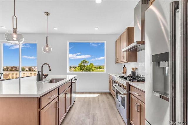900 Eldorado Ln, Louisville, CO 80027 - kitchen with appliances with stainless steel finishes, wall chimney exhaust hood, light wood-type flooring, recessed lighting, and light countertops