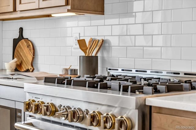 900 Eldorado Ln, Louisville, CO 80027 - kitchen view of decorative backsplash, stainless steel stove, and light countertops