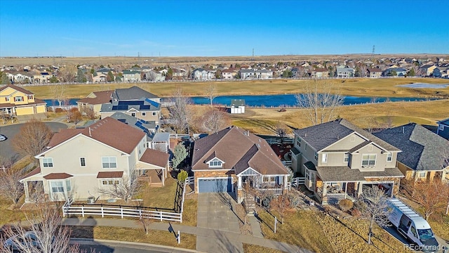 birds eye view of property with a water view and a residential view