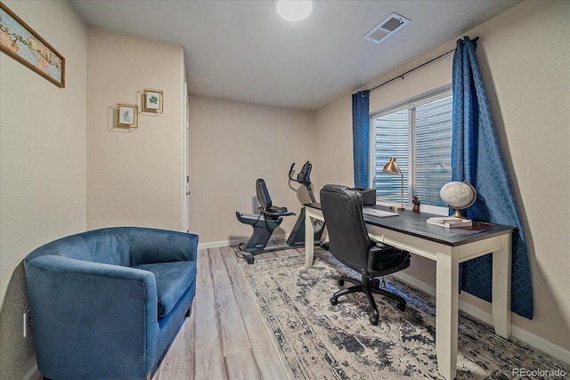 office with wood finished floors, visible vents, and baseboards