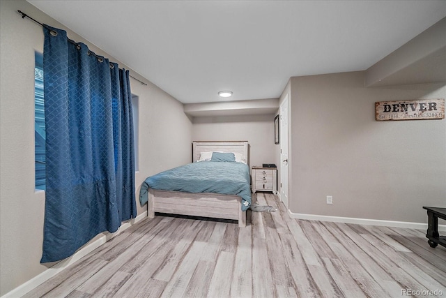 bedroom featuring baseboards and wood finished floors