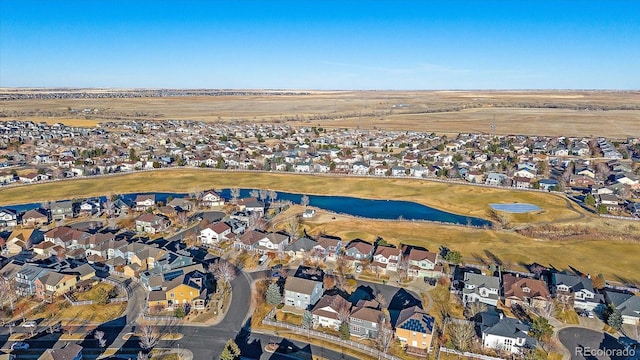 drone / aerial view featuring a water view and a residential view