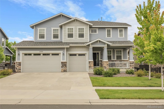 23895 E Rocky Top Pl, Aurora, CO 80016 - craftsman-style home with a garage, a porch, driveway, a front yard, and roof with shingles