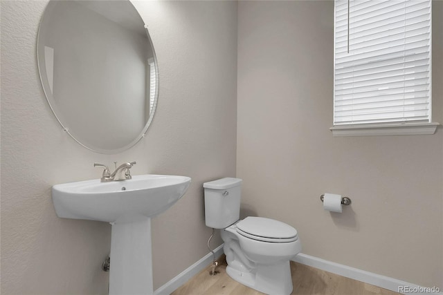 23895 E Rocky Top Pl, Aurora, CO 80016 - bathroom featuring toilet, wood finished floors, baseboards, and a sink