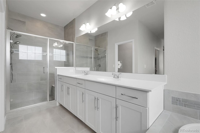 23895 E Rocky Top Pl, Aurora, CO 80016 - full bathroom with double vanity, a shower stall, and tile patterned floors