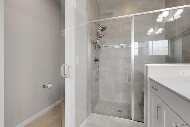 23895 E Rocky Top Pl, Aurora, CO 80016 - full bathroom featuring a stall shower, vanity, and baseboards