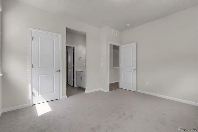 23895 E Rocky Top Pl, Aurora, CO 80016 - unfurnished bedroom featuring carpet floors, baseboards, and connected bathroom
