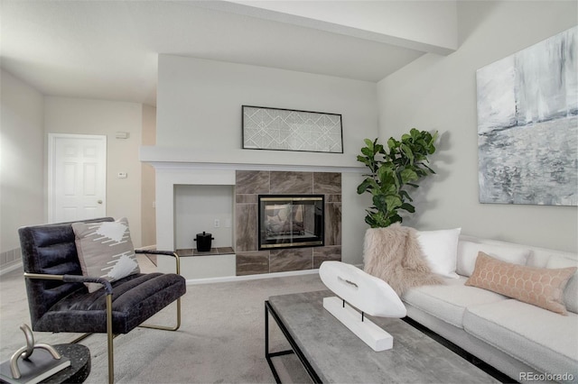 living room with carpet floors and a fireplace