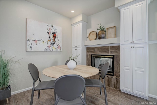 dining room with a fireplace and light wood-type flooring