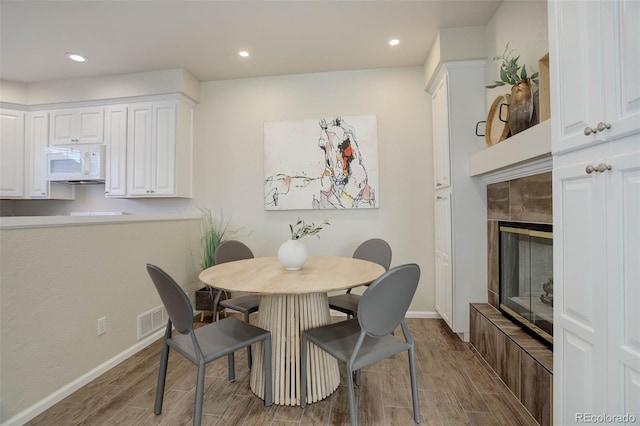 dining space with a tile fireplace