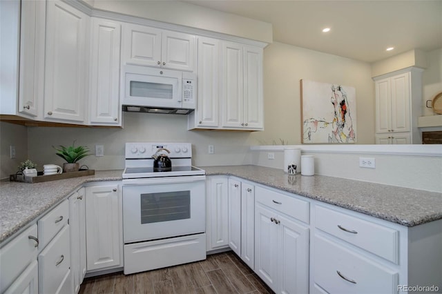 kitchen with light stone counters, white appliances, dark hardwood / wood-style floors, and white cabinets