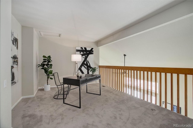 carpeted office featuring lofted ceiling with beams