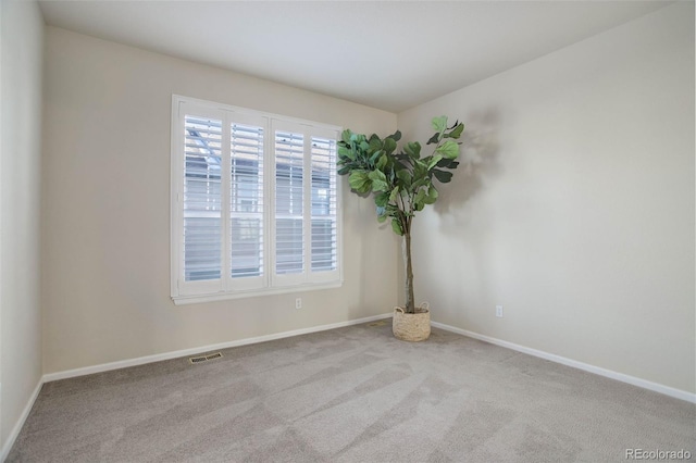 spare room with light colored carpet