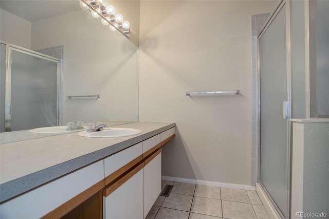 bathroom with vanity, a shower with shower door, and tile patterned flooring