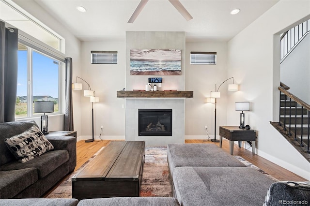 23814 E 36th Pl, Aurora, CO 80019 - living area featuring wood finished floors, stairway, a tiled fireplace, recessed lighting, and a ceiling fan