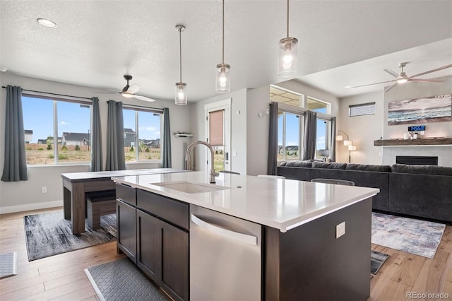 23814 E 36th Pl, Aurora, CO 80019 - kitchen with stainless steel dishwasher, ceiling fan, light wood finished floors, open floor plan, and a textured ceiling