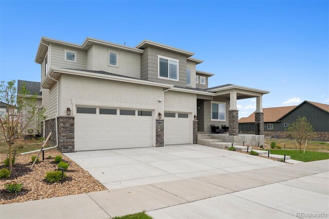 23814 E 36th Pl, Aurora, CO 80019 - prairie-style house with a garage, stone siding, concrete driveway, stucco siding, and a porch