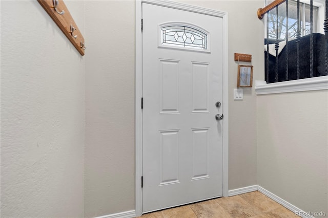 entryway featuring baseboards