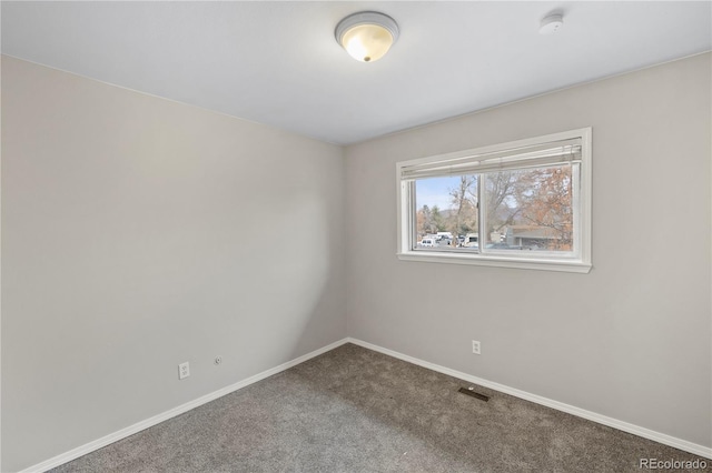 spare room with visible vents, baseboards, and carpet floors