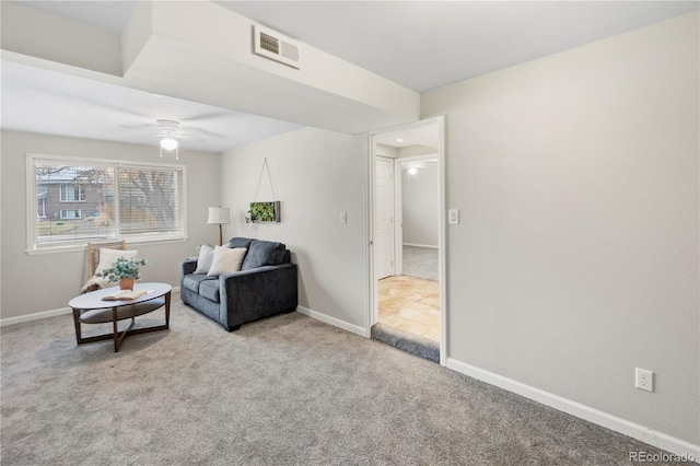 sitting room with a ceiling fan, baseboards, visible vents, and carpet floors