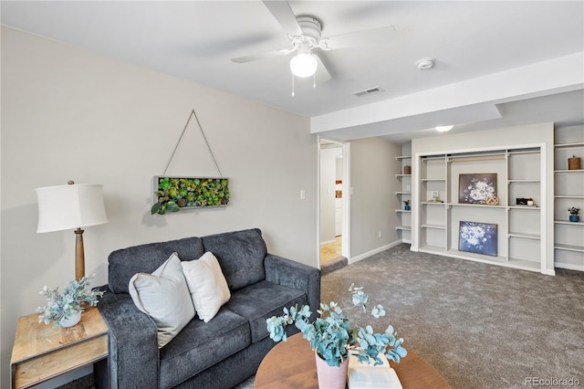 carpeted living area with baseboards, visible vents, and ceiling fan