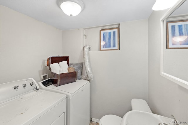 clothes washing area featuring washer and dryer and laundry area