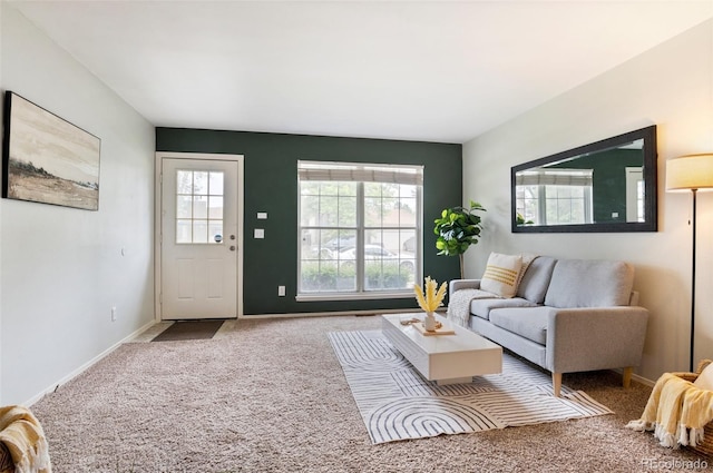 carpeted living area with baseboards